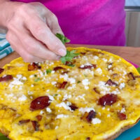 Sprinkling parsley and fresh cheese on a recipe