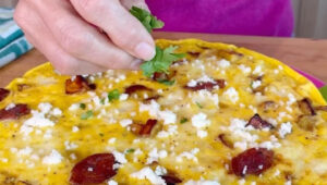 Sprinkling parsley and fresh cheese on a recipe