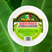 Cheese container over banana leaves background